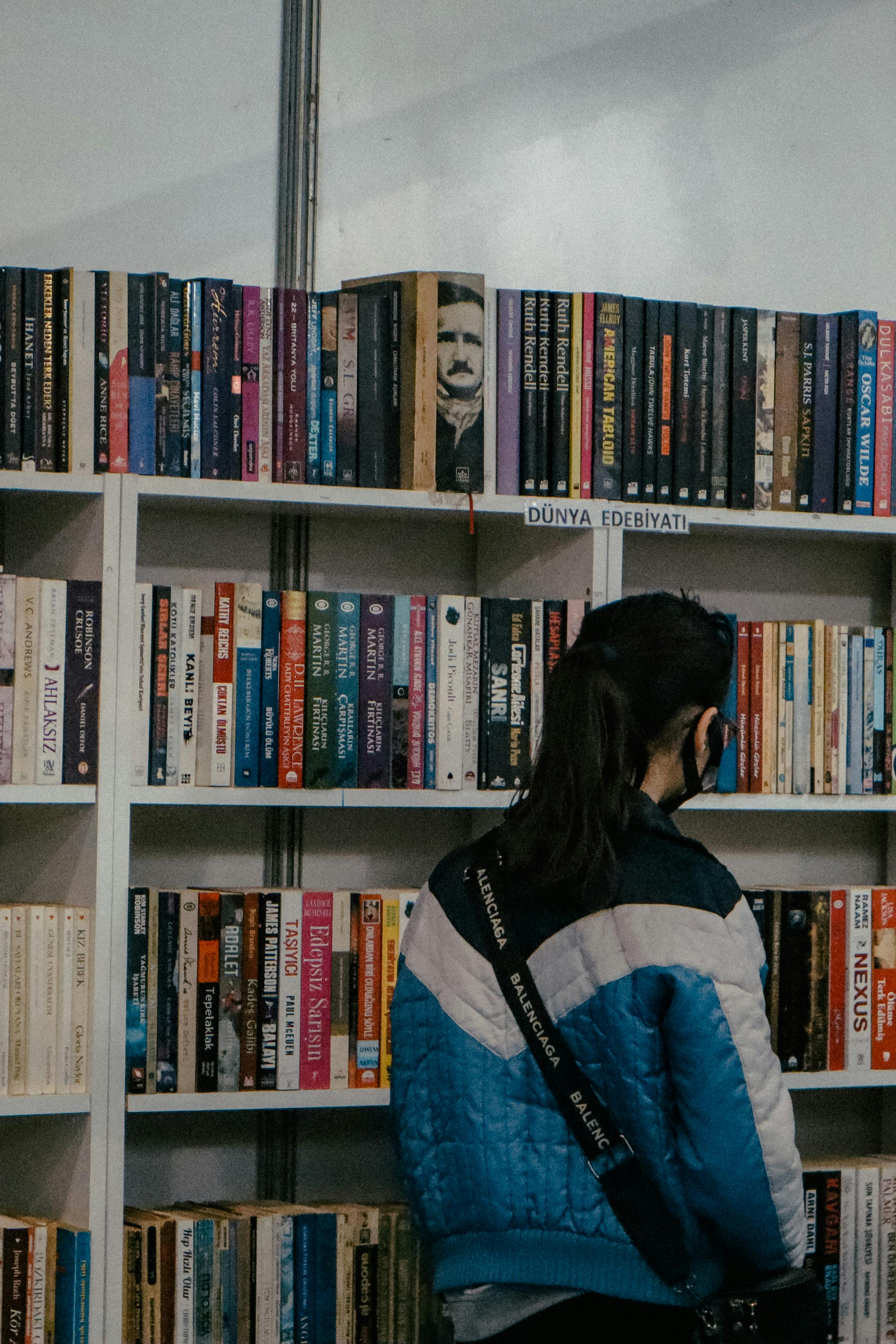 a person looking at books in a bookstore