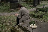 A Man Sitting by a Grave