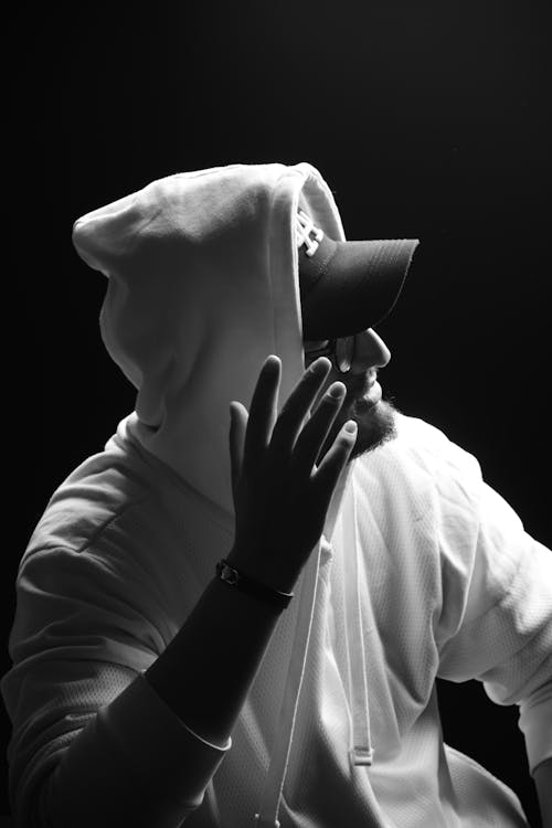 Free Grayscale Photo of Man in Hoodie Wearing Cap  Stock Photo