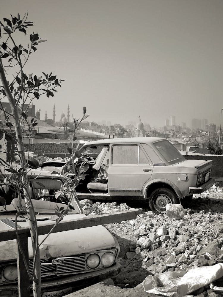 Grayscale Photo Of Abandoned Cars