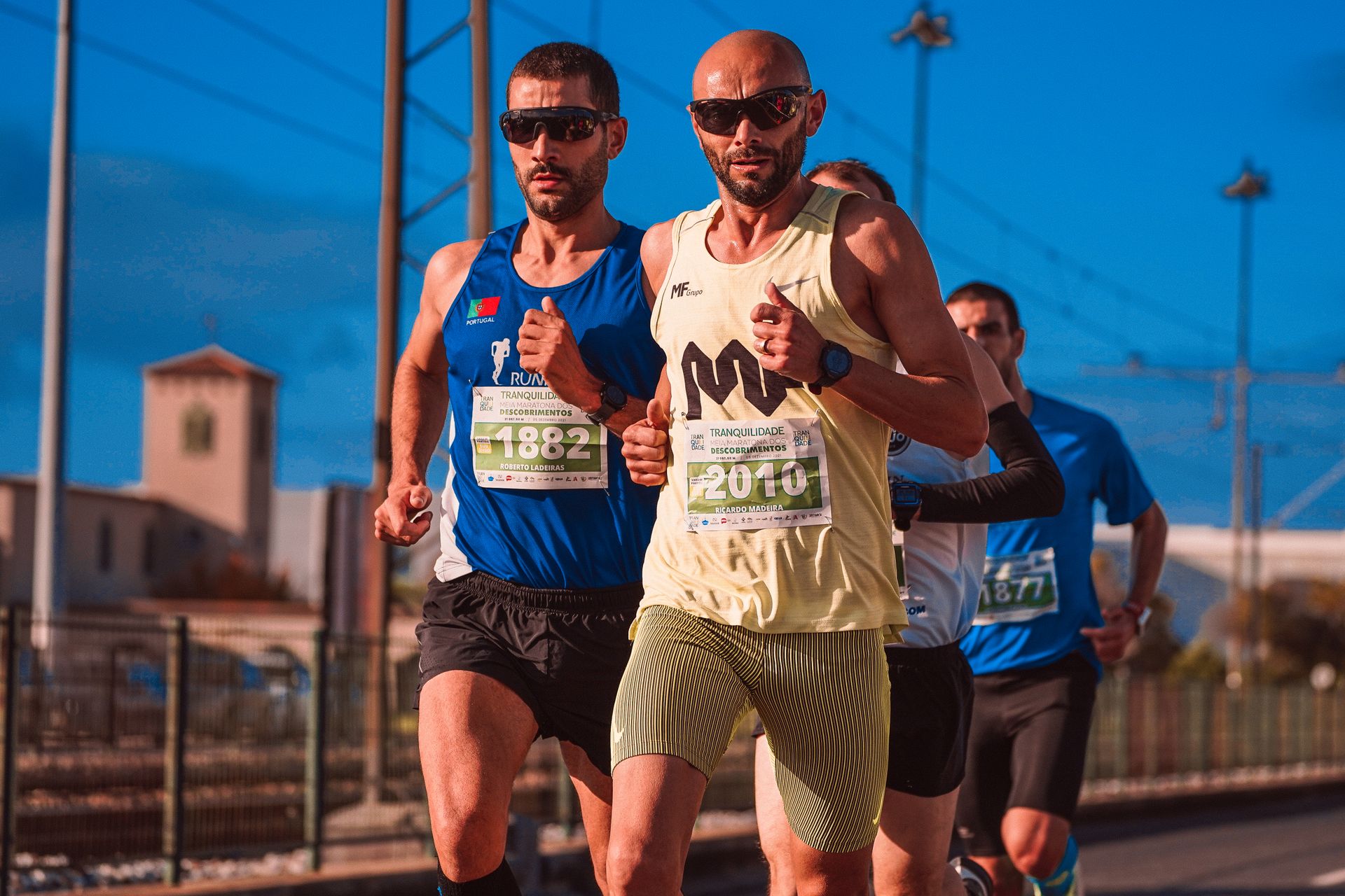 Male athletes compete in an intense marathon race, showcasing endurance and determination outdoors.