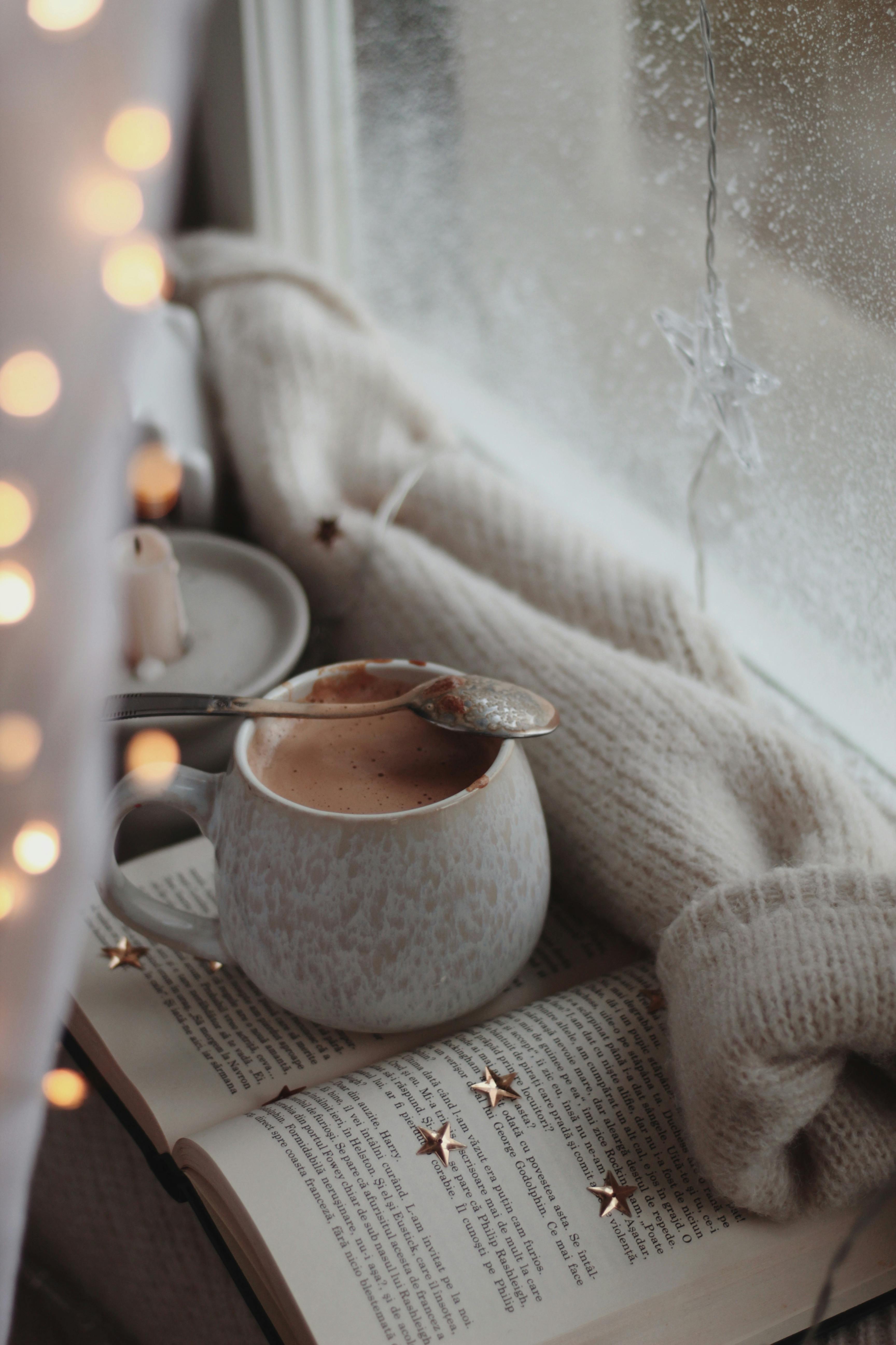 A Cup of Hot Cocoa on an Open Book · Free Stock Photo