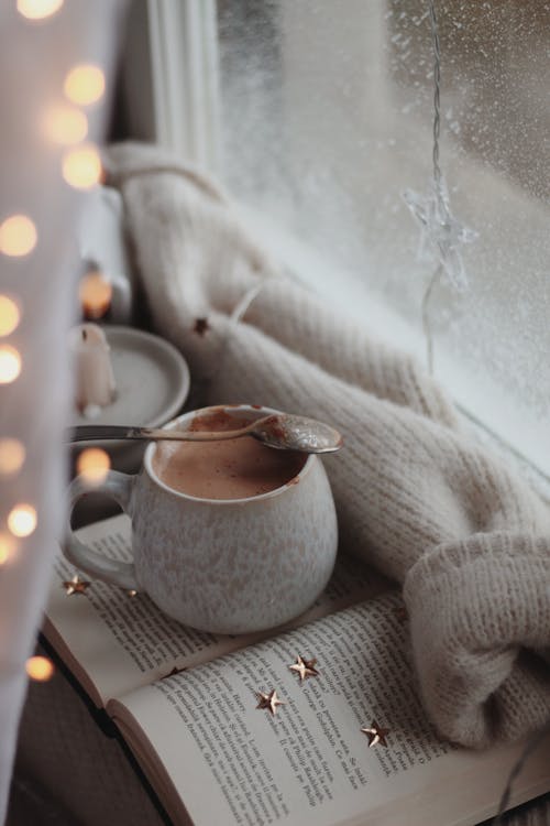 Free A Cup of Hot Cocoa on an Open Book Stock Photo