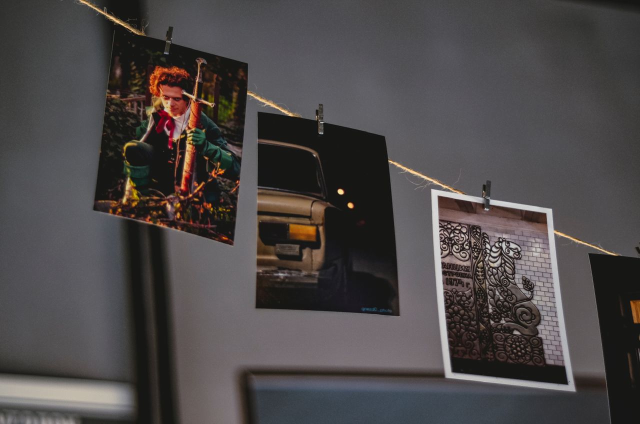 three photo prints hanging on a string showcasing different scenes
