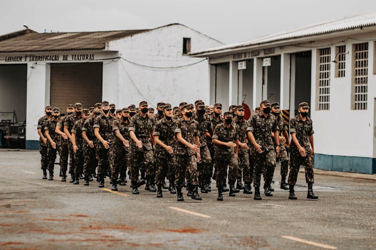 Men Wearing Military Uniforms Marching