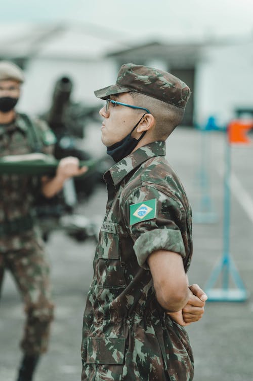 A Soldier Standing Wearing Eyeglasses