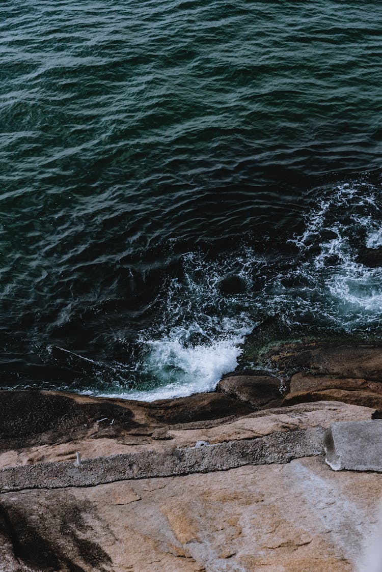 High Angle Shot Of Waves Crashing On The Shore