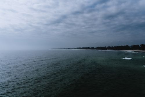 Free An expansive view of the ocean under a cloudy sky, creating a dramatic seascape. Stock Photo