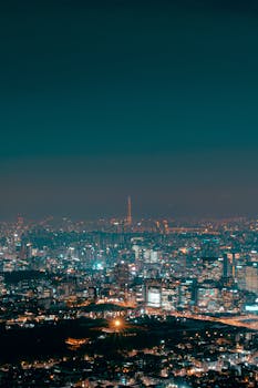 Stunning view of Seoul's cityscape at night, highlighting modern architecture and city lights.