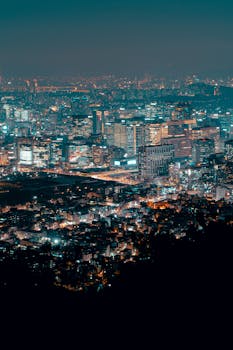 Explore the vibrant city skyline illuminating the night with modern architecture and dazzling lights.