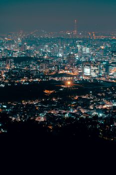 Breathtaking aerial view of a vibrant city skyline illuminated at night, showcasing urban beauty.