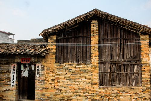Free Traditional brick farmhouse with wooden roof and Asian script at entrance. Stock Photo