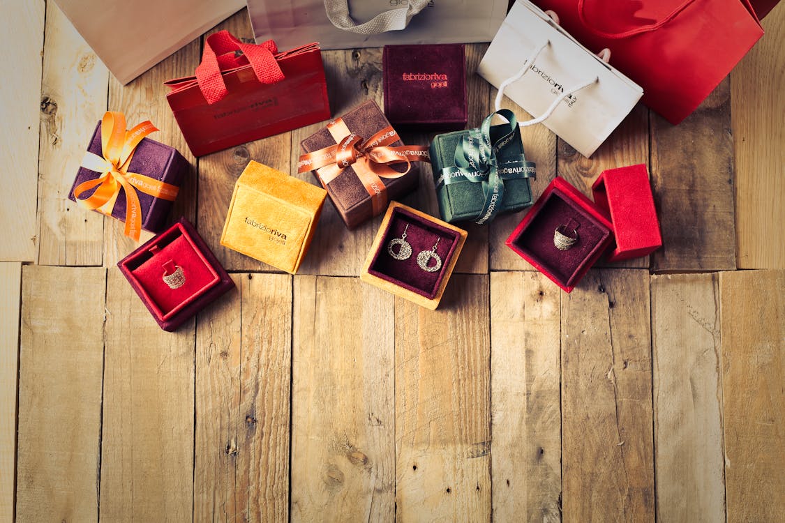 Free Assorted Gift Boxes on Brown Wooden Floor Surface Stock Photo