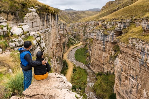 A couple enjoys a breathtaking view of a canyon and river in Jauja, Peru, showcasing the natural beauty of Junín.