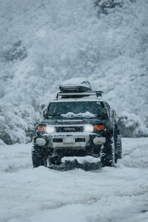 Free Toyota SUV driving through heavy snow in Utah, showcasing winter adventure. Stock Photo