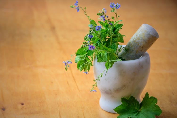 Purple Petaled Flowers In Mortar And Pestle