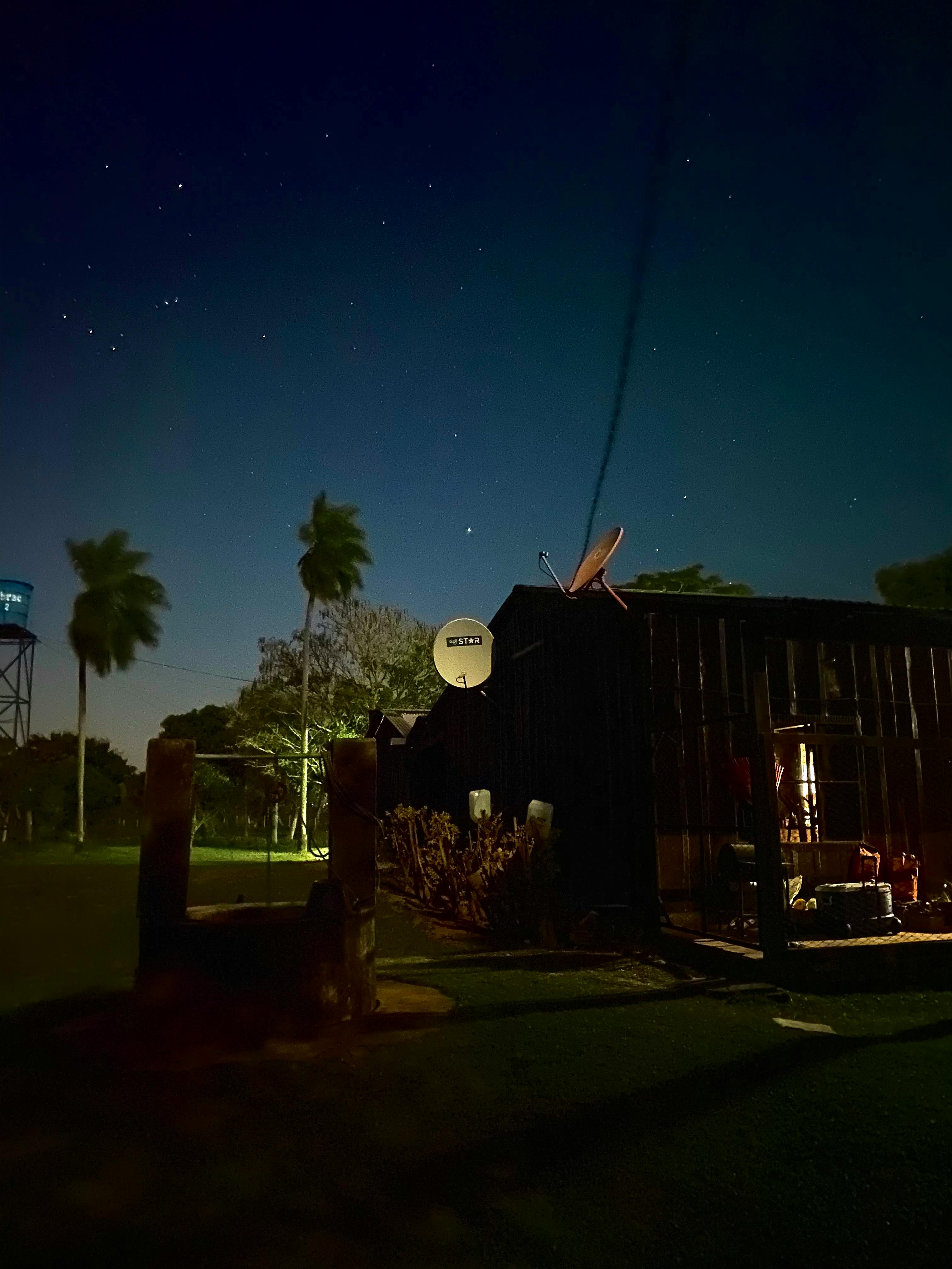 Loose leaf herbal tea blend and a glass teapot on a wooden board