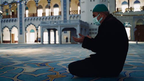 A Man Praying in a Mosque