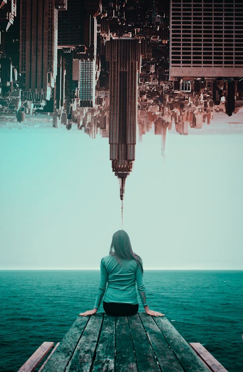 Photo of Woman and inverted Buildings