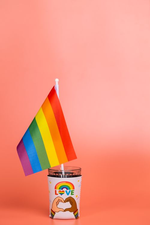 Free Image of a rainbow flag in a cup with a love theme, highlighting pride and equality. Stock Photo