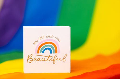 Free Gay Pride Slogan against Rainbow Flag Stock Photo
