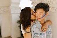 Gay Pride Couple Embracing and Kissing