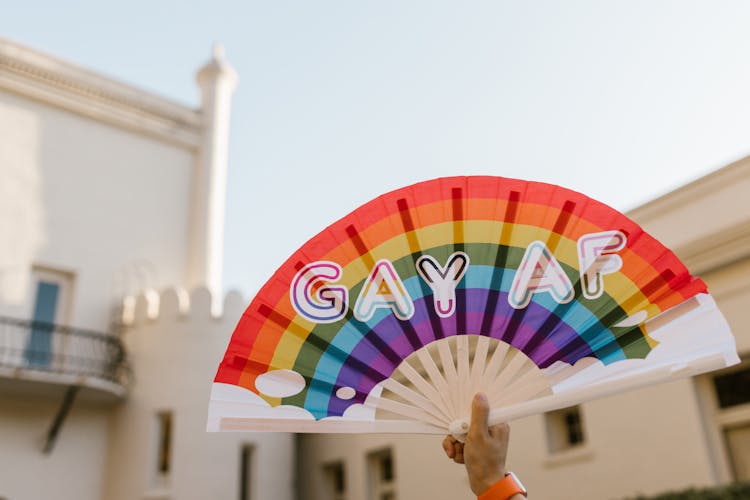 Hand Holding Rainbow Hand Fan