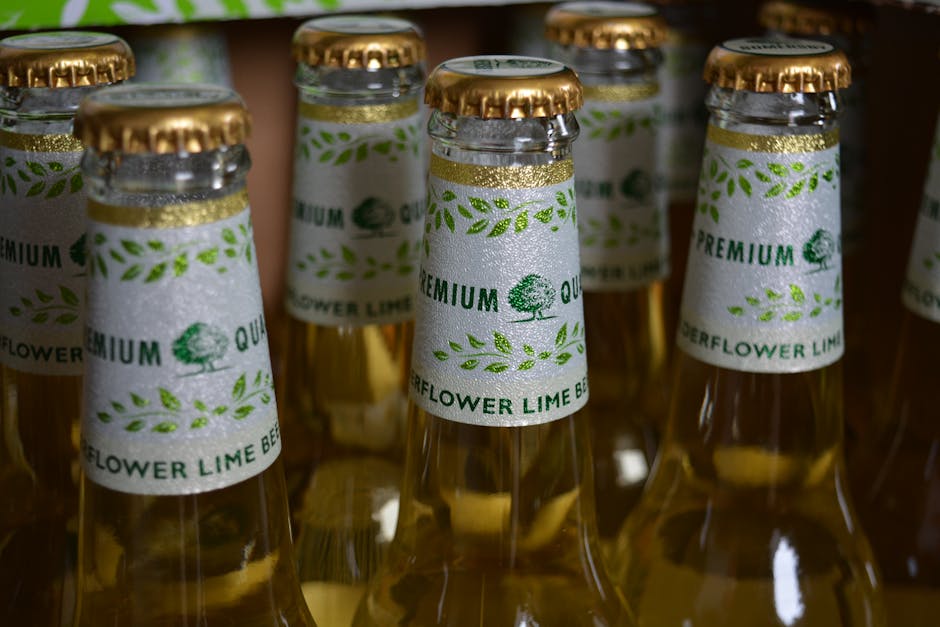 Close-up of elderflower lime beer bottles with premium labels in a package.