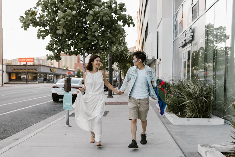 Lesbian Couple Walking Down Street Holding Hands