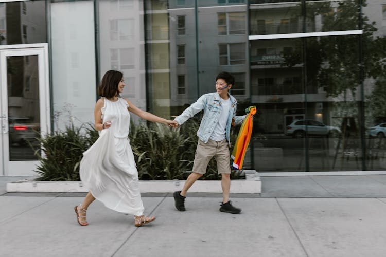 Lesbian Couple Walking Down Street Holding Hands