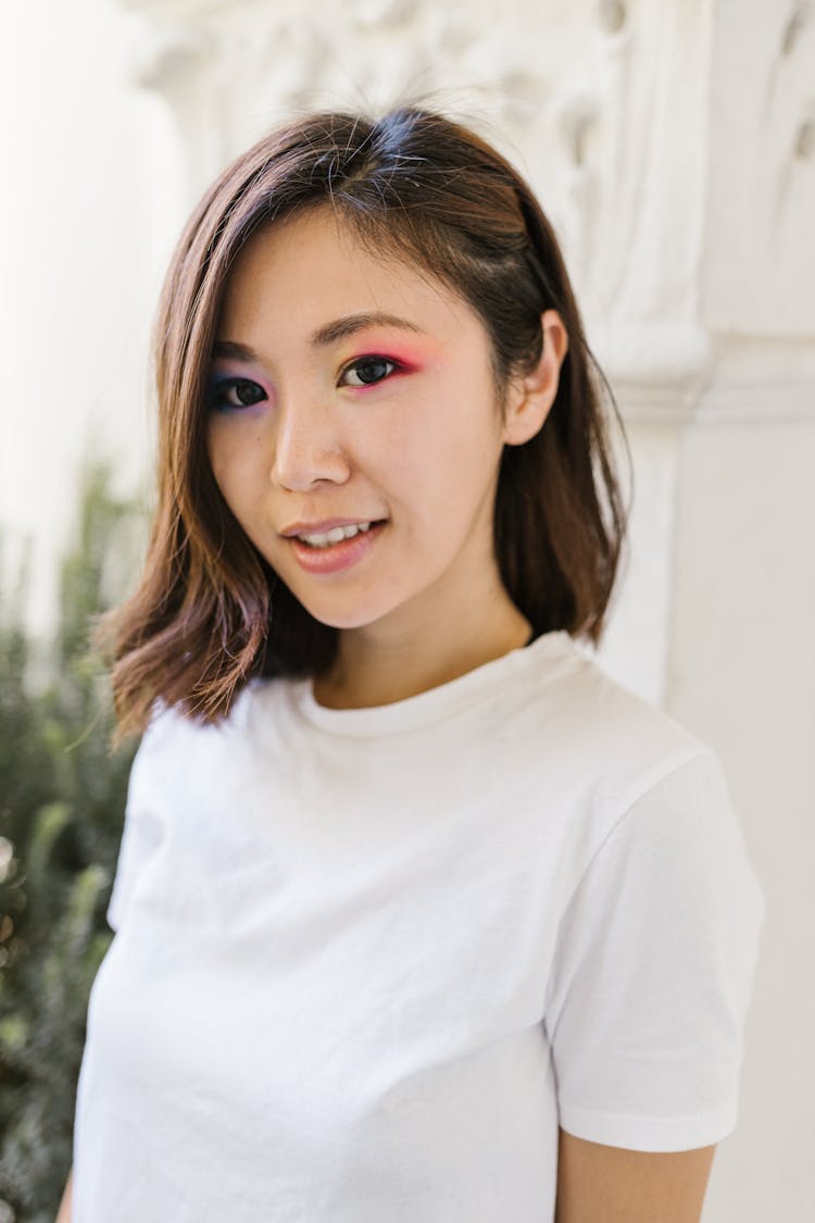 Smiling Young Woman With Dark Hair And White T-Shirt