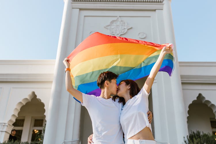 Two Lesbian Girls Kissing Each Other And Carrying Rainbow Flag