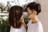 Two Lesbian Women Standing Face to Face and Looking at Each Other with Affection