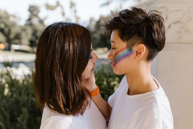 Two Lesbian Women Standing Face To Face And Looking At Each Other With Affection