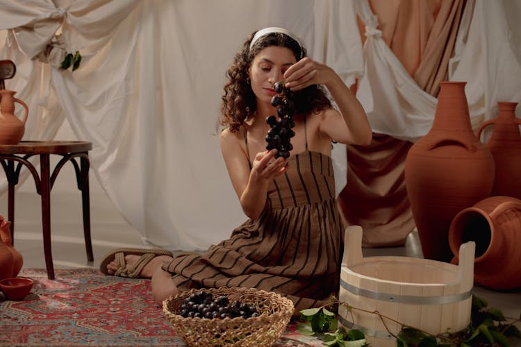 Woman Wearing Roman Costume Making Wine