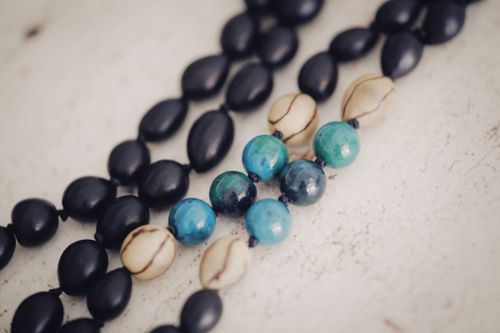 Free Artistic macro shot of vibrant blue, black, and cream beads in a fashion accessory necklace. Stock Photo