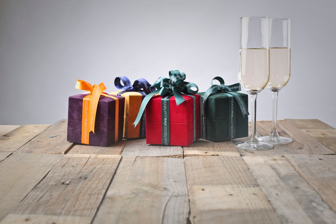 Colorful wrapped gift boxes and celebration glasses arranged on a table