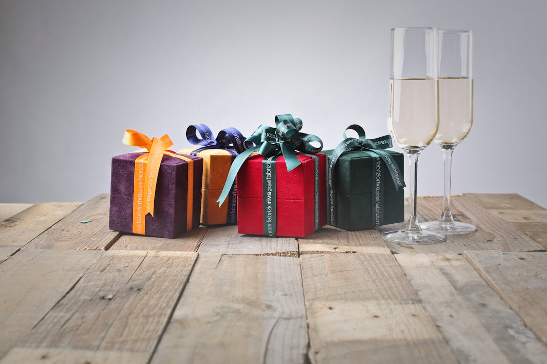 Free Five Assorted Gift Boxes and Two Flute Glasses Stock Photo