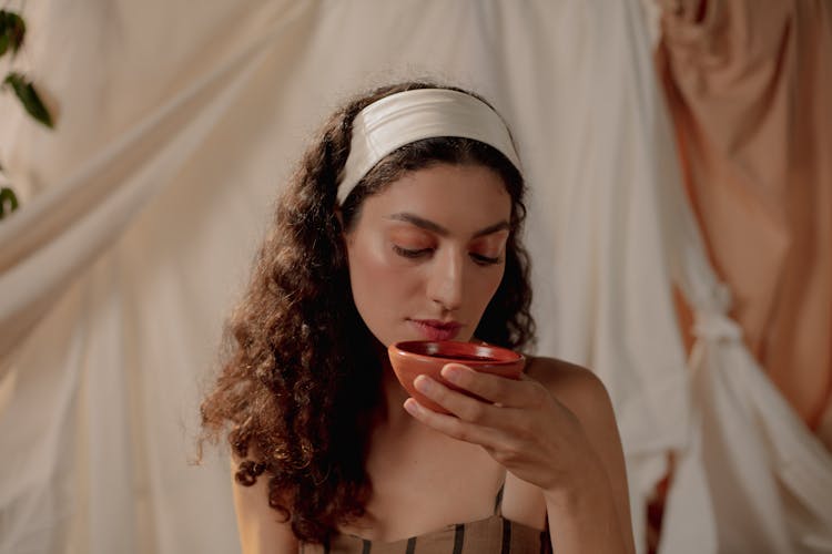 Woman Drinking Wine From Ceramic Cup