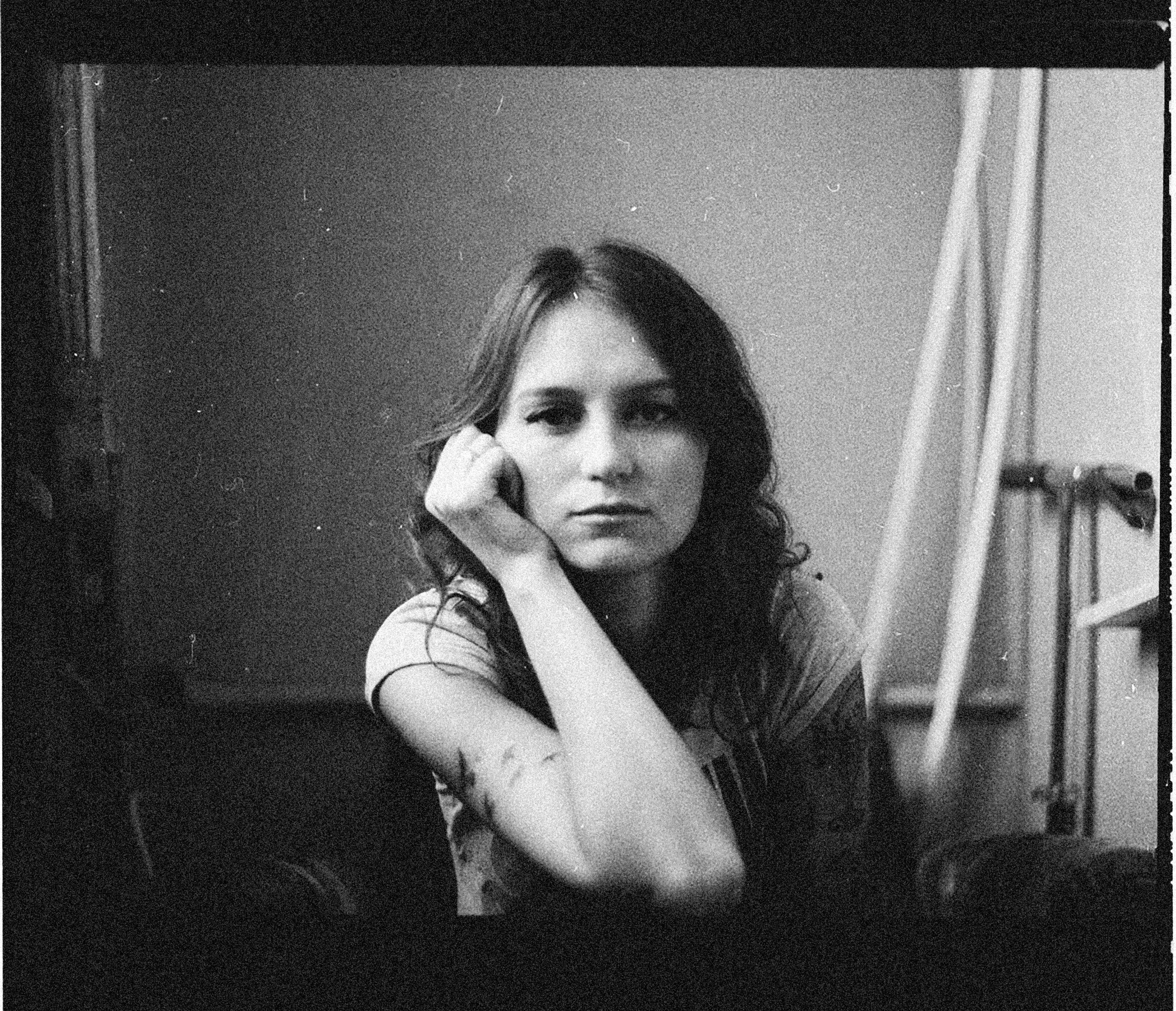 Artistic black and white portrait of a woman with a contemplative expression.
