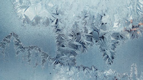 Close Up Shot of Snow Covered Glass Panel