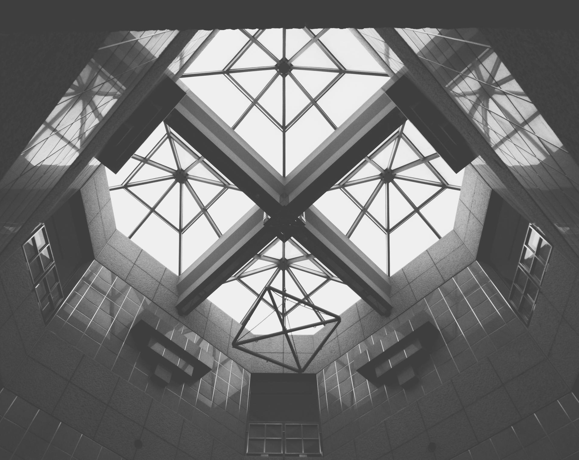 A stunning low angle view of a geometric skylight with intricate patterns in black and white.