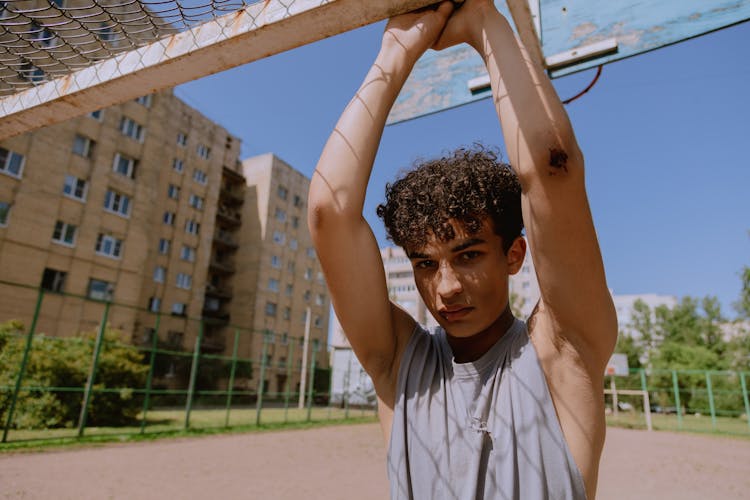 A Boy In Gray Tank Top With Wound On His Elbow