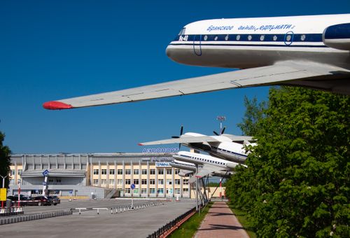 Free Scenic view of vintage airplanes on display outside a Russian airport terminal. Stock Photo