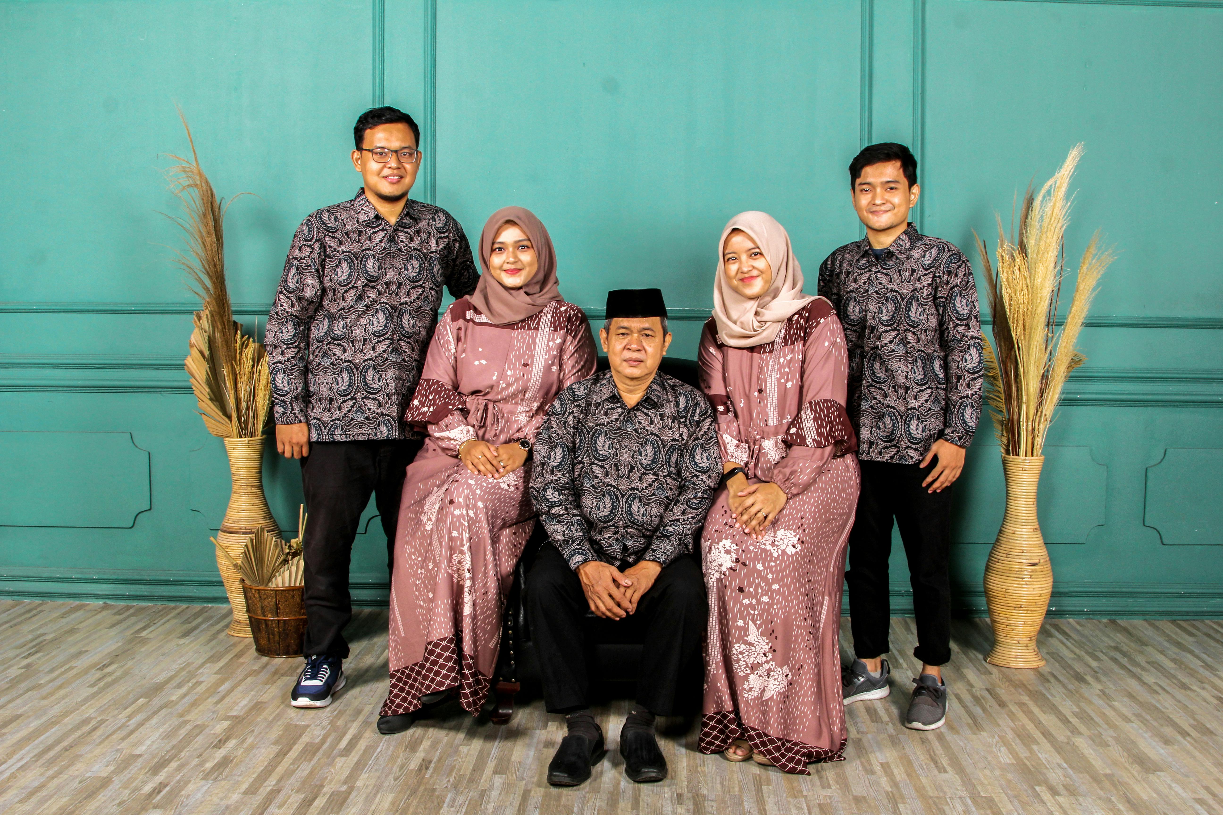 dubai wedding abaya - Family group portrait in coordinated traditional attire indoors, showcasing cultural fashion.