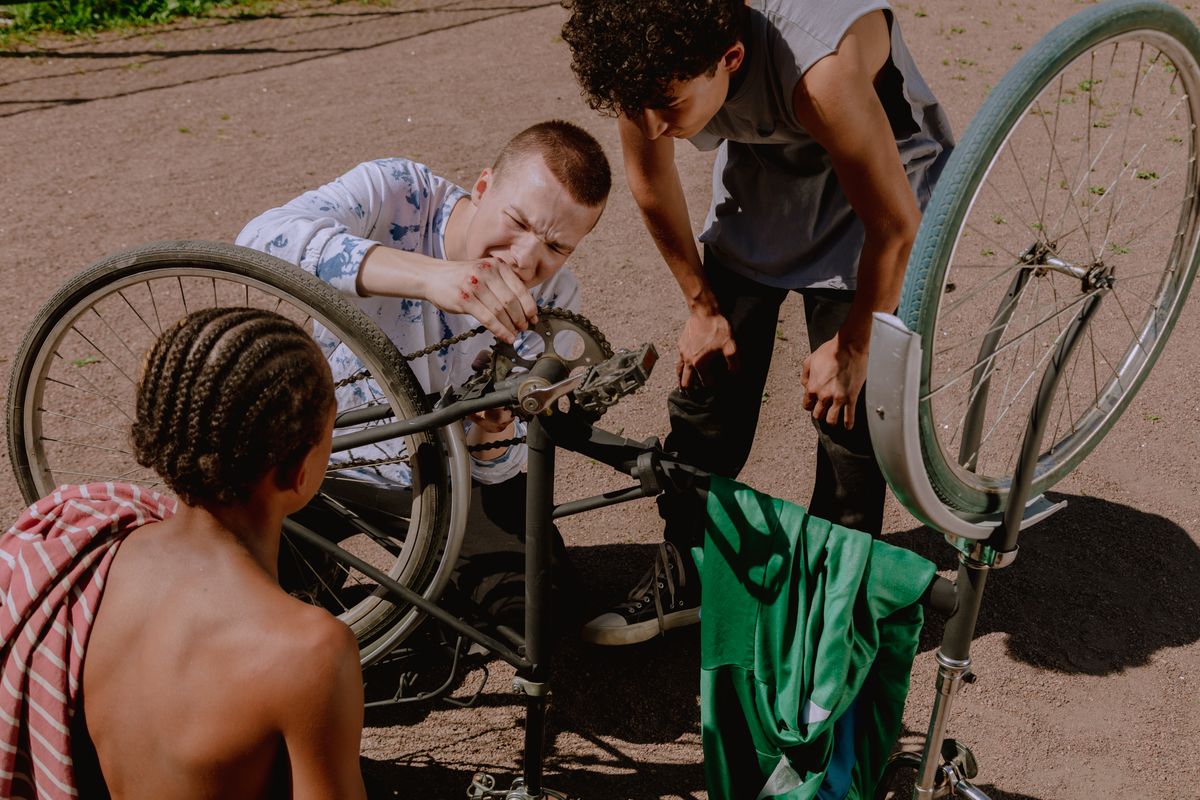People working together on a bicycle repair outdoors