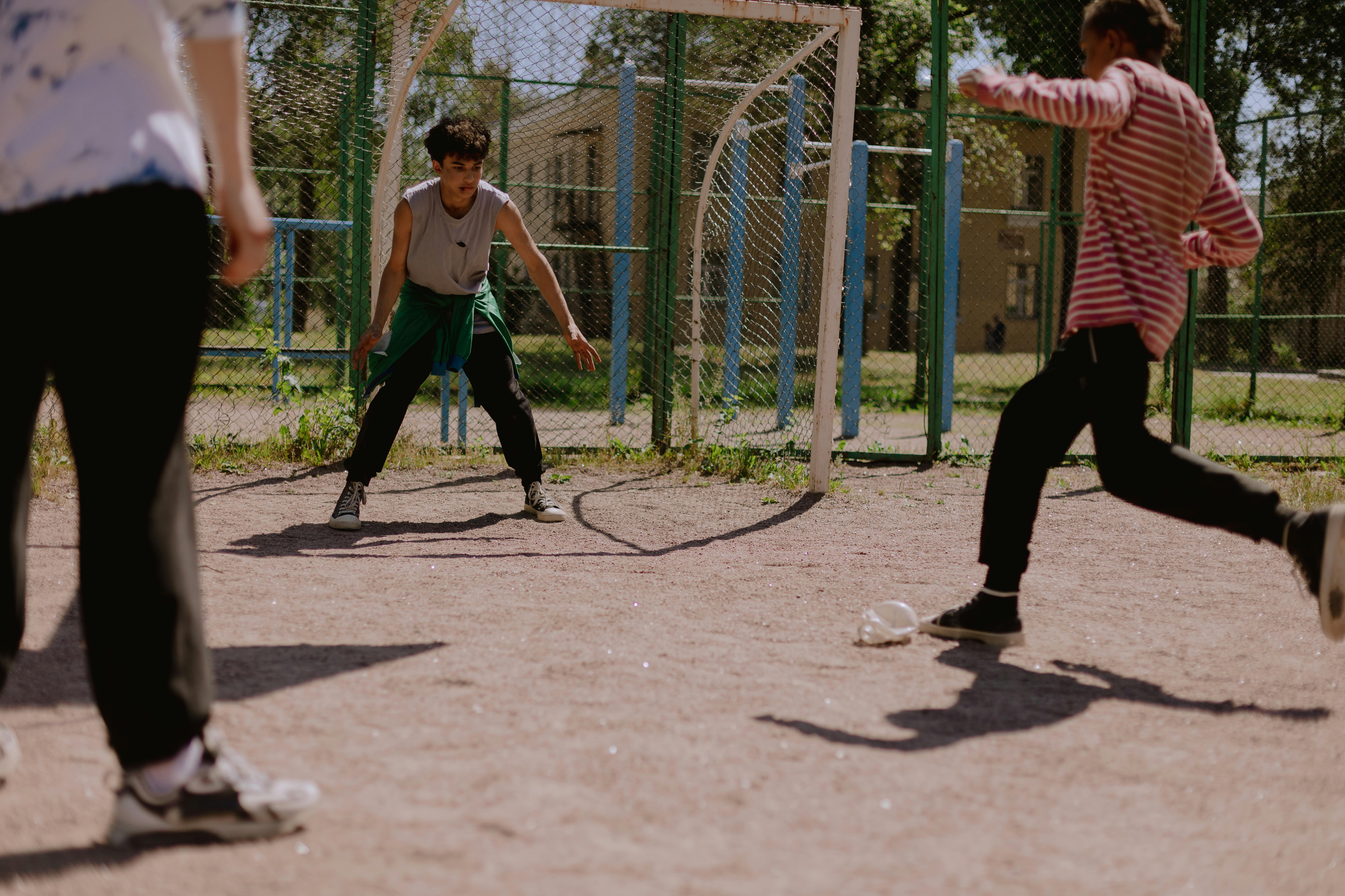 Free A group of teenagers playing an energetic soccer game outdoors. Stock Photo