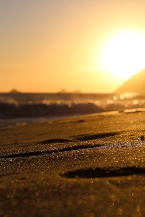 Close-Up Shot of Seashore Sand during Sunset