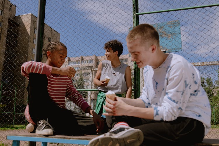 Group Of Young Men Eating Ice Cream