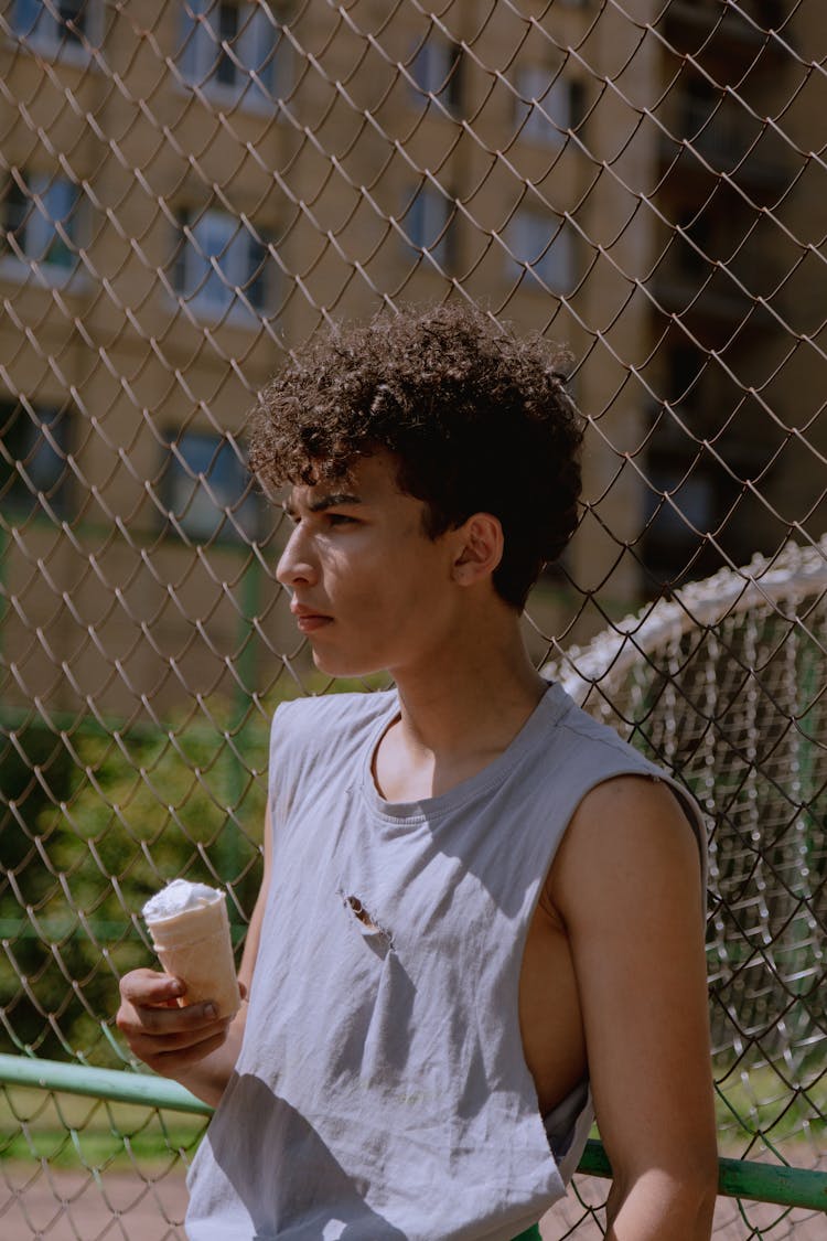 Teenage Boy Holding An Ice Cream